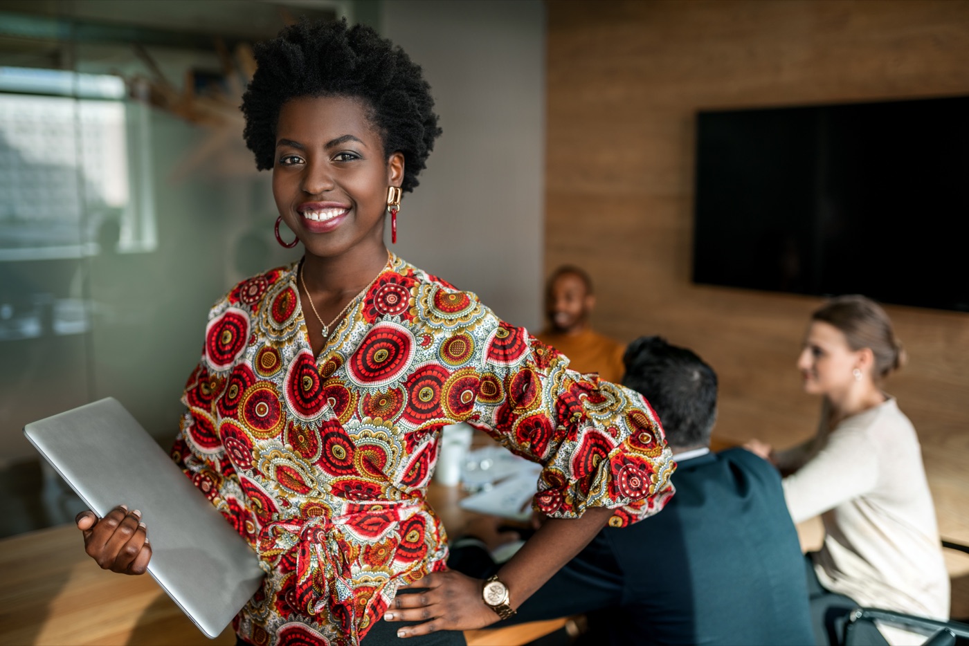 Professional woman with laptop in modern office